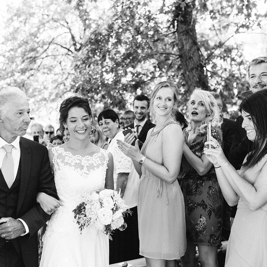 Bridal Entrance in Lace Wedding Dress | Outdoor Wedding at Commanderie de Peyrassol, Provence, France Styled by La Chuchoteuse | Lace Bridal Gown | Black Tie Suit | Rustic Stretch Tent Reception | Raisa Zwart Photography