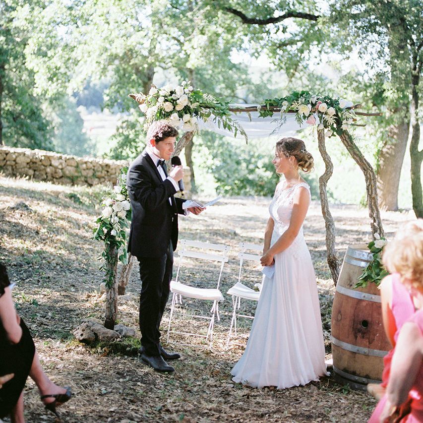 Wedding Ceremony | Elegant Bride in Lace Wedding Dress | Groom in Black Tie Suit | Outdoor Wedding at Commanderie de Peyrassol, Provence, France Styled by La Chuchoteuse | Lace Bridal Gown | Black Tie Suit | Rustic Stretch Tent Reception | Raisa Zwart Photography