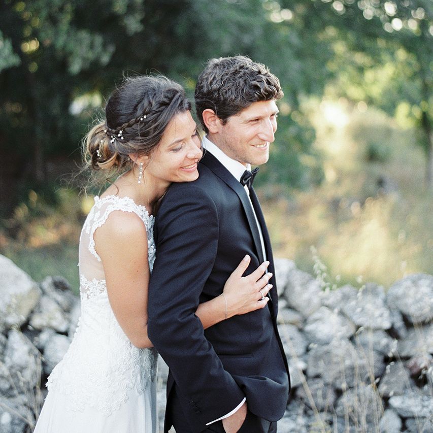 Elegant Bride in Lace Wedding Dress | Groom in Black Tie Suit | Outdoor Wedding at Commanderie de Peyrassol, Provence, France Styled by La Chuchoteuse | Lace Bridal Gown | Black Tie Suit | Rustic Stretch Tent Reception | Raisa Zwart Photography
