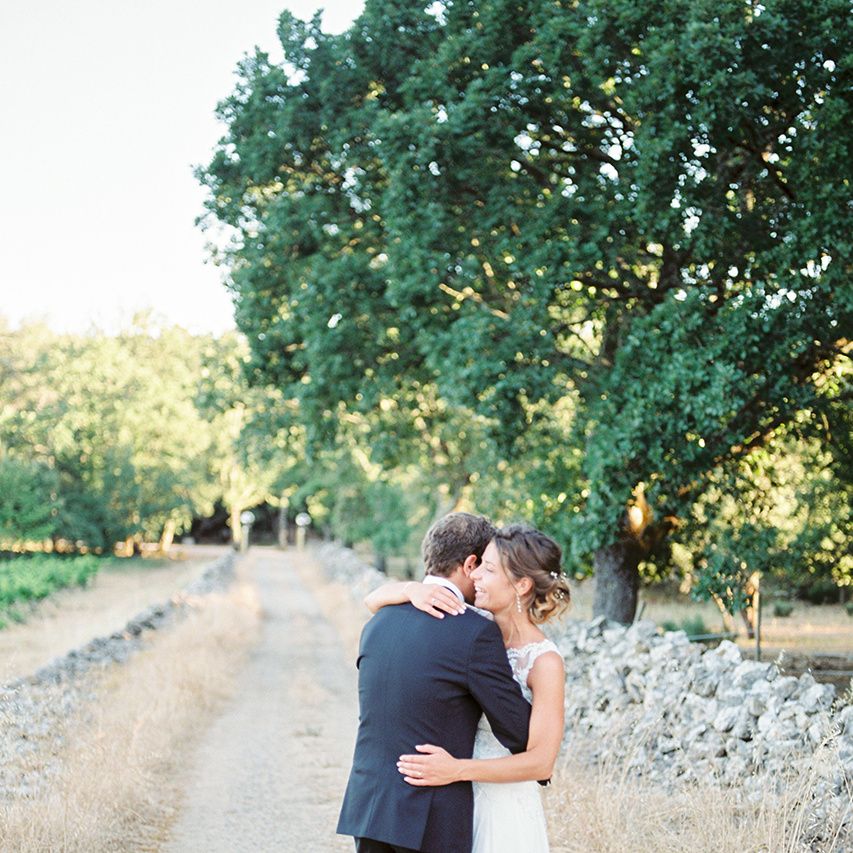 Elegant Bride in Lace Wedding Dress | Groom in Black Tie Suit | Outdoor Wedding at Commanderie de Peyrassol, Provence, France Styled by La Chuchoteuse | Lace Bridal Gown | Black Tie Suit | Rustic Stretch Tent Reception | Raisa Zwart Photography