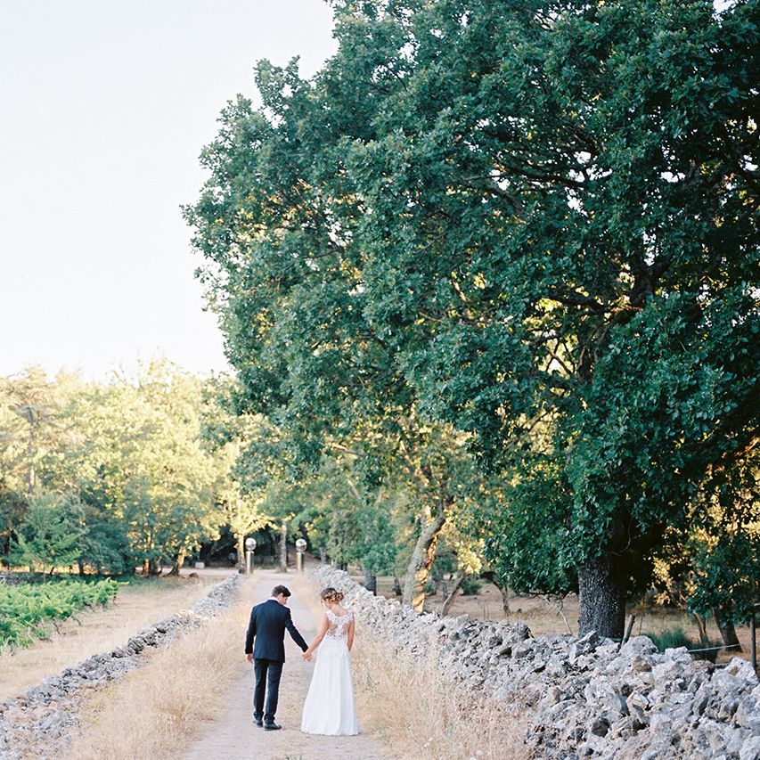 Elegant Bride in Lace Wedding Dress | Groom in Black Tie Suit | Outdoor Wedding at Commanderie de Peyrassol, Provence, France Styled by La Chuchoteuse | Lace Bridal Gown | Black Tie Suit | Rustic Stretch Tent Reception | Raisa Zwart Photography