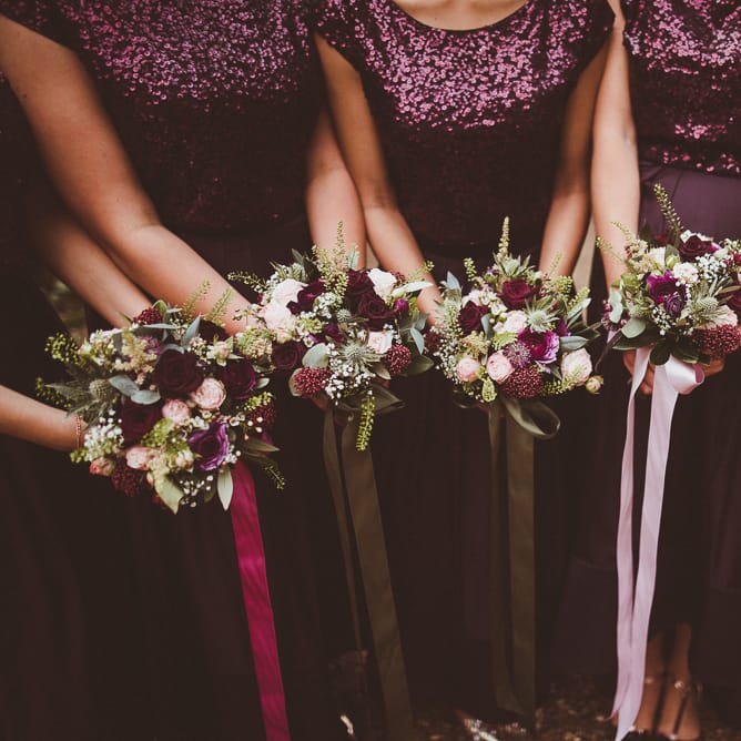Bouquets with Ribbon | Bridesmaids in Coast Burgundy Separates | Sequin Tops &amp; High Low Skirts | Bride in Lillian West Bridal Separates | Burgundy &amp; Gold Winter Wedding at Ramster Hall Weddings, Surrey | Matt Penberthy Photography | John Harris Wedding Films