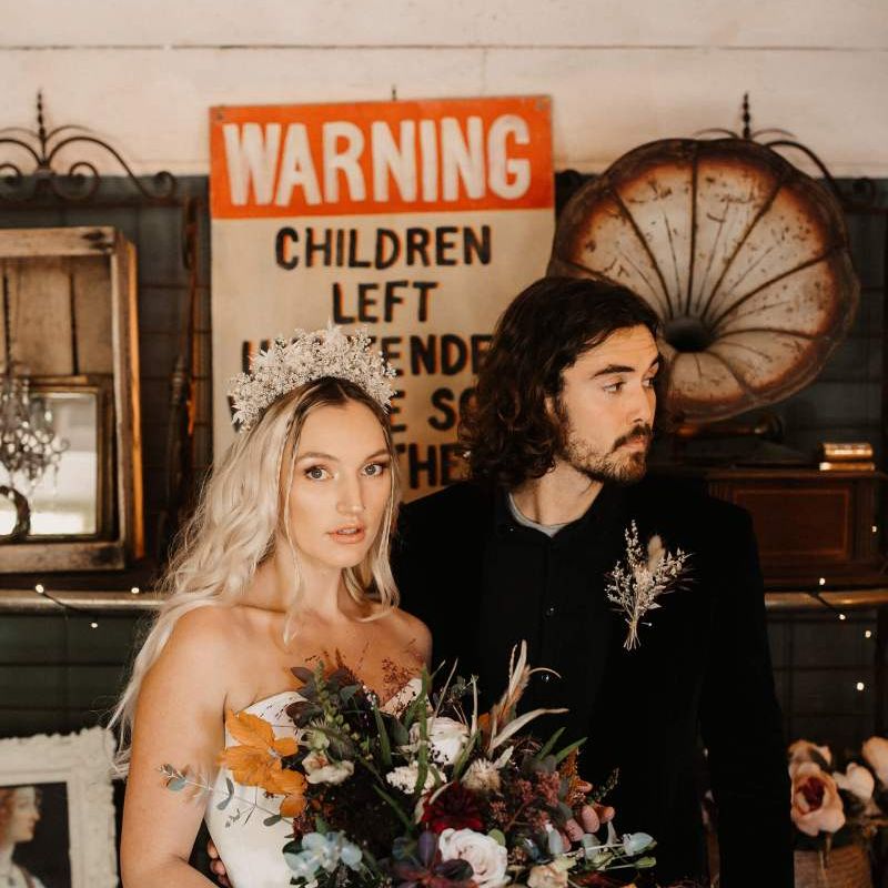 Alternative bride and groom with bride in bridal gown