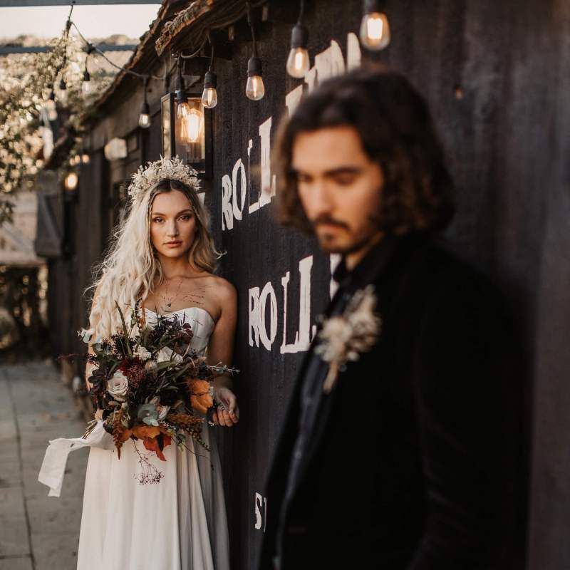 Bride in strapless wedding dress with autumn wedding bouquet for Halloween wedding