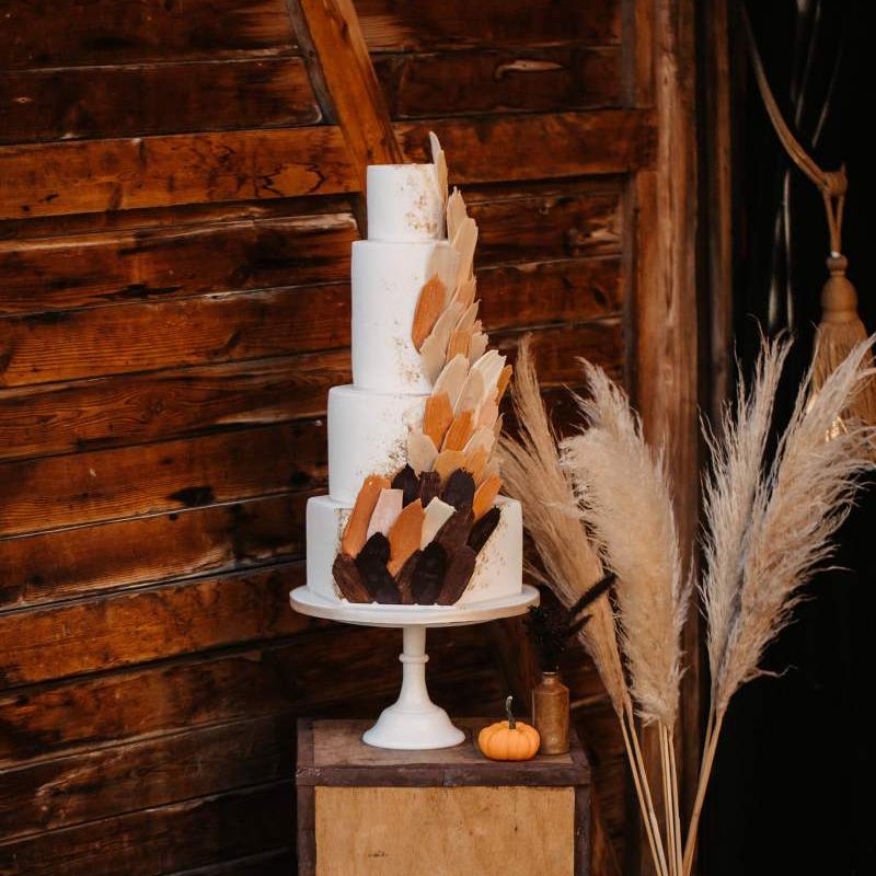Wedding cake with pumpkins, crates and dried flower Halloween wedding decor