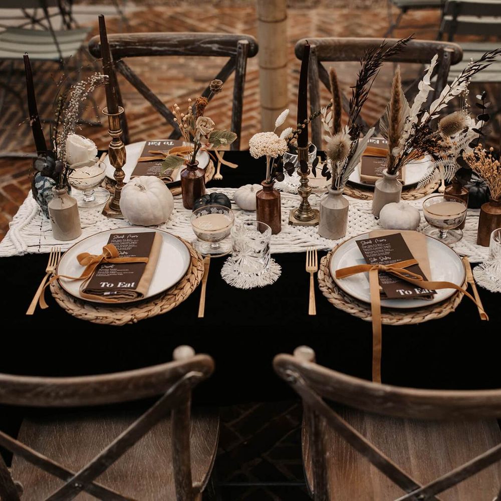 Black table cloth, macrame table runner, white pumpkins and dried flower wedding table decor