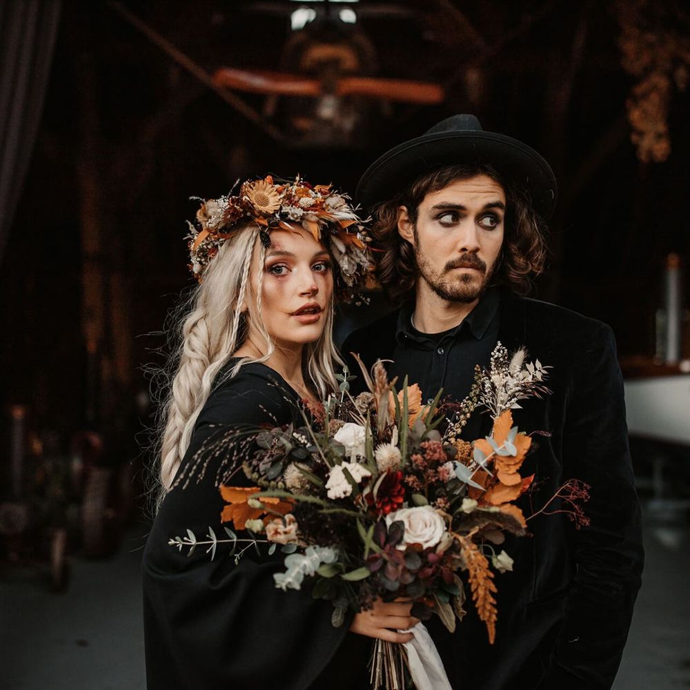 Bride with orange and dried flower bouquet and flower crown at Halloween wedding shoot