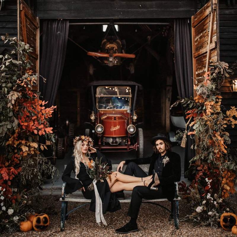 Preston court shed with bride and groom sitting on a bench for Halloween wedding
