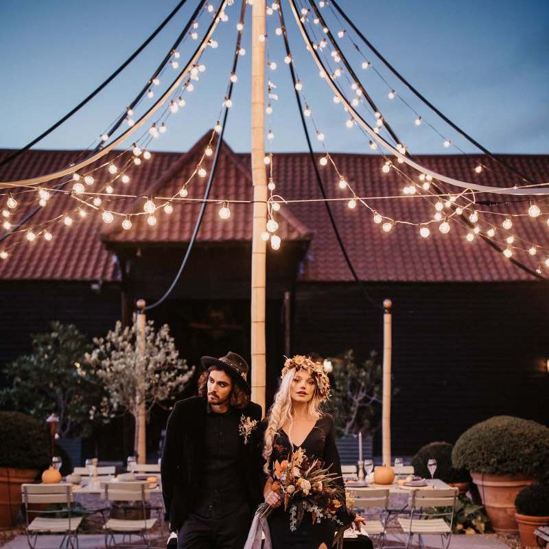 Outdoor seating area at Preston Court with festoon light canopy