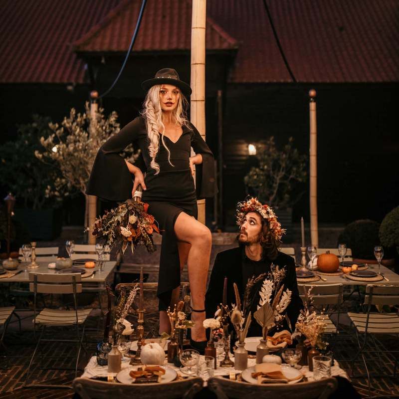 Bride standing on the intimate table at Preston Court Halloween wedding