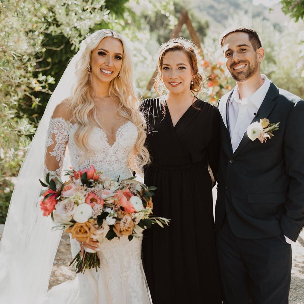 Bride and groom with their celebrant at Bride in lace wedding dress at California elopement