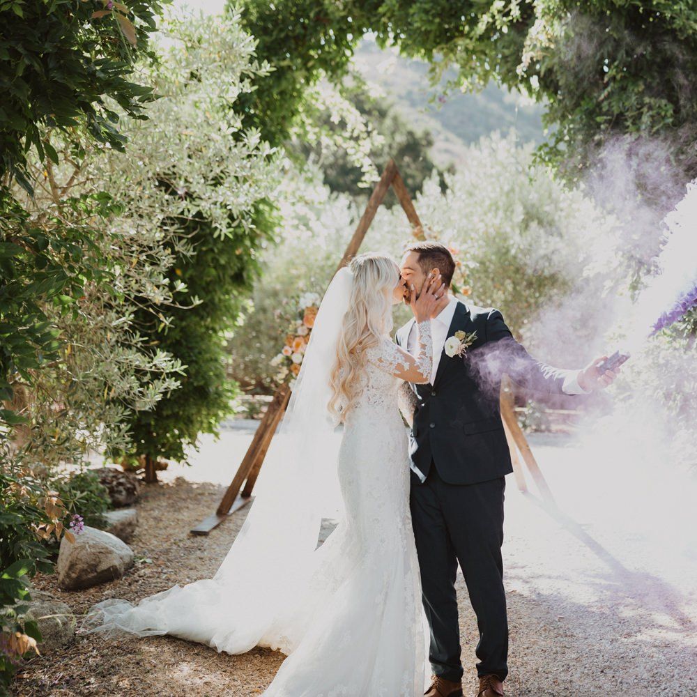 Bride and groom smoke bomb portrait