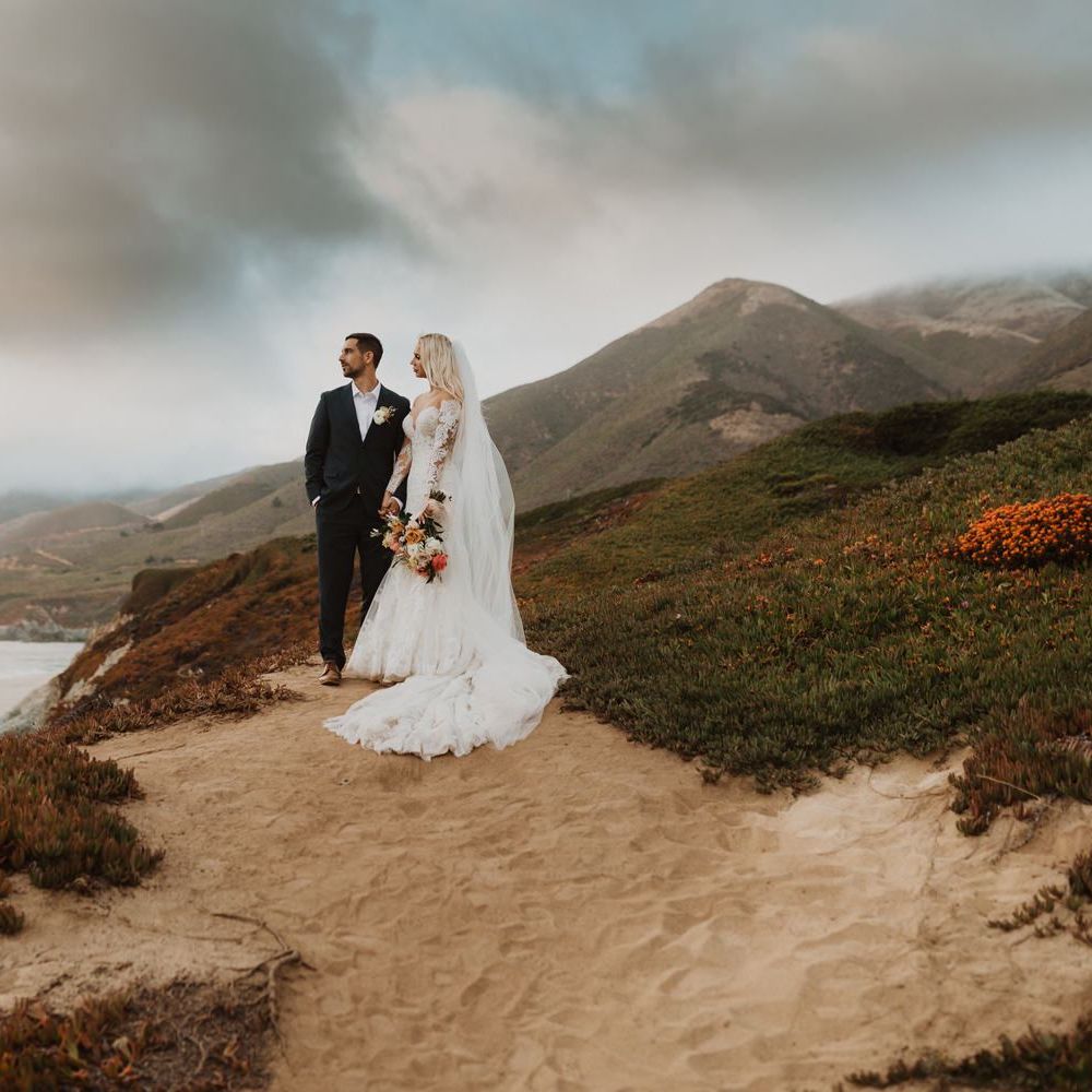 Bride in lace Pronovias wedding dress and groom in navy suit at intimate elopement