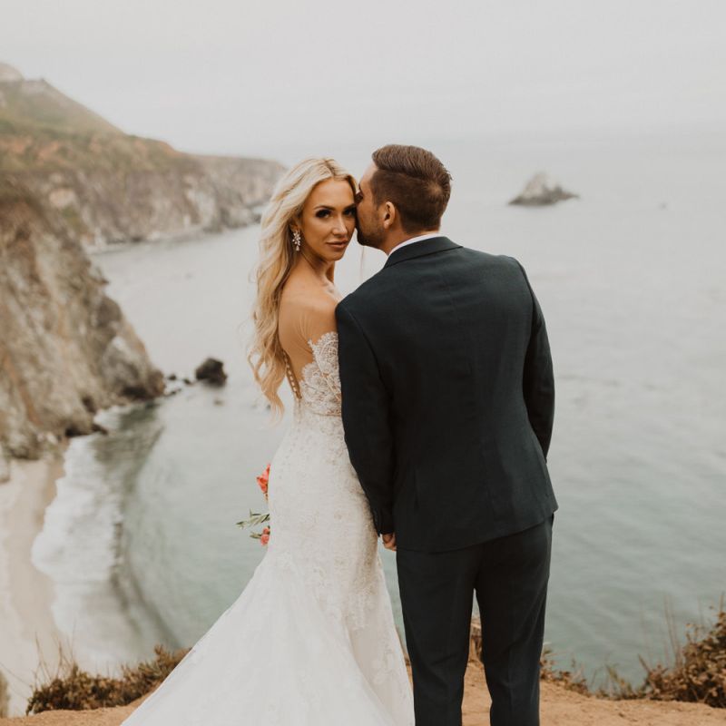 Bride and groom coastal portrait by Ariele Chapman Photography