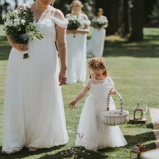 Bridesmaids And Flower Girls In White Dresses // Blush Pink Wedding Dress For Outdoor Wedding Ceremony At Hethfelton House With Images From Dorset Wedding Photographer Paul Underhill