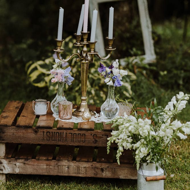 Wooden Pallets Decorated with Miniature Milk Churns, and Brass Candelabra