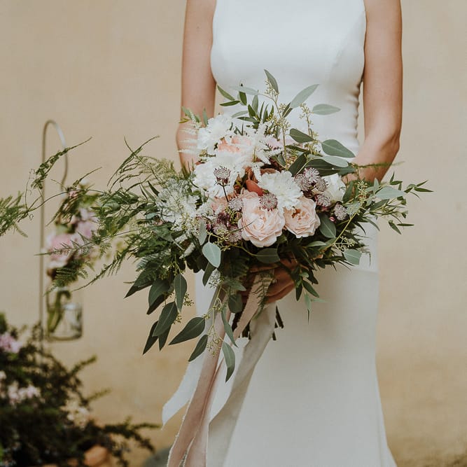 Bride in Fitted Mikaella Bridal Wedding Dress Holding Her Bouquet