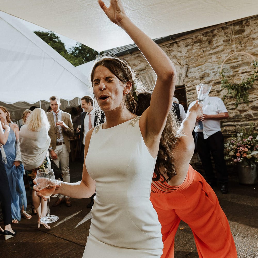 Bride in High Neck Mikaella Bridal Fitted Wedding Dress Enjoying The Evening Reception