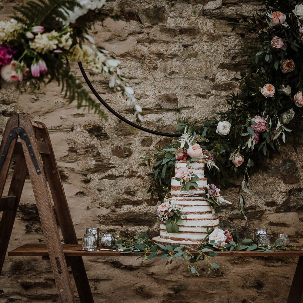 Semi Naked Wedding Cake on Rustic Ladder Table Top with Flower Hoop Backdrop