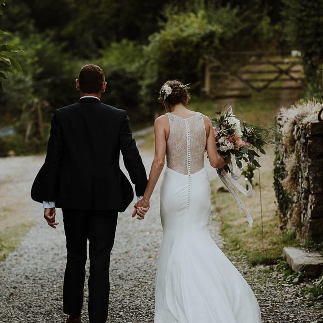 Bride in Lace Back Mikaella Bridal Fitted Wedding Dress and Groom in  Clifton Suit