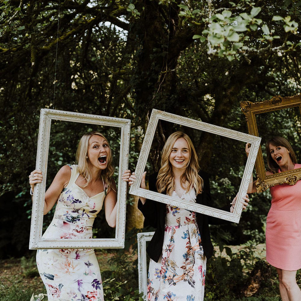 Hanging Picture Frames From Tree as Photo Booth Station