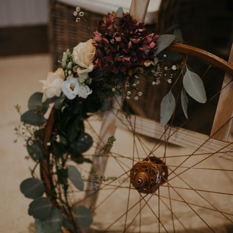 Vintage wheel wedding decor covered in flowers