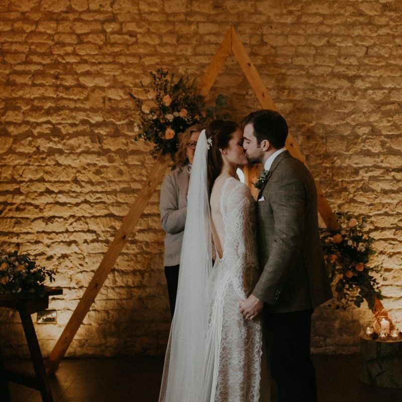 Bride and groom kissing at Lapstone Barn wedding ceremony