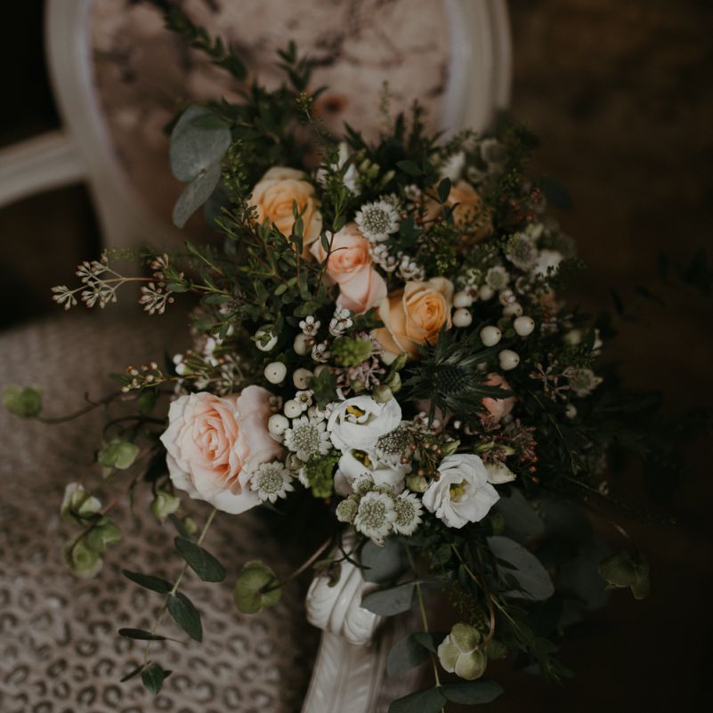 Peach and white flower wedding bouquet with foliage