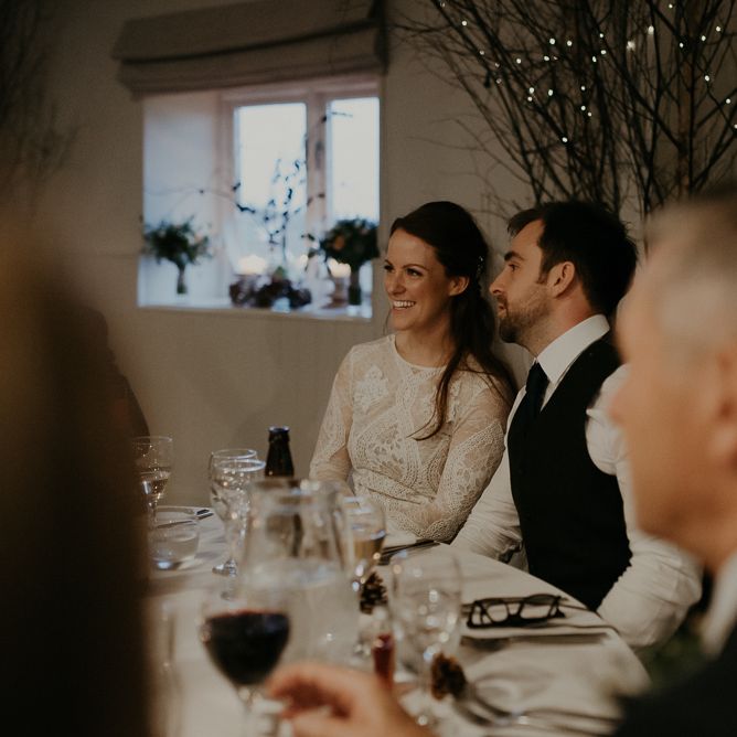 Bride and groom smiling during Lapstone Barn wedding reception