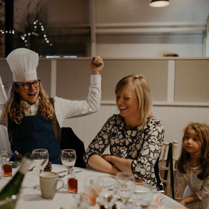 Wedding guest wearing chefs hat during wedding breakfast