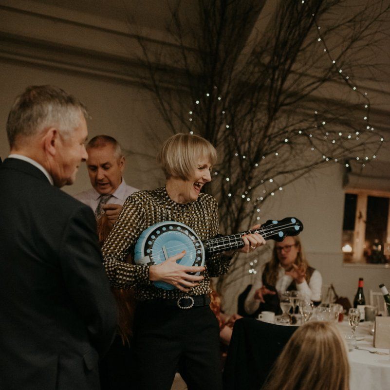 Wedding guest playing with inflatable guitar