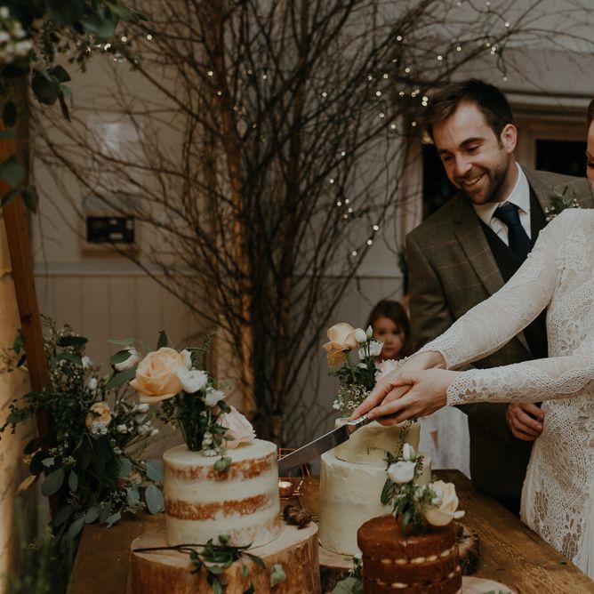 Bride and groom cutting the wedding cake at Lapstone Barn