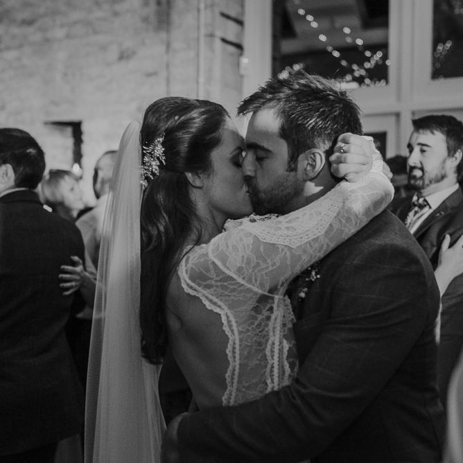 Bride and groom kissing on the dance floor