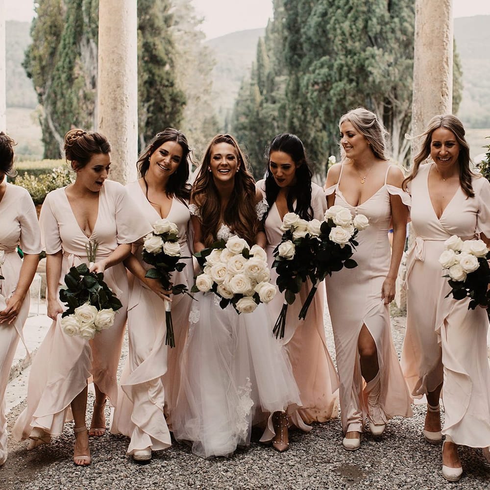 Pink bridesmaid dresses with white bouquets with bride in Galia Lahav wedding dress
