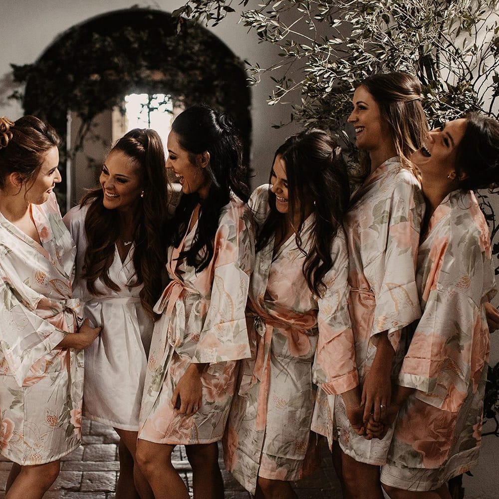 Bride with bridesmaids in getting ready robes