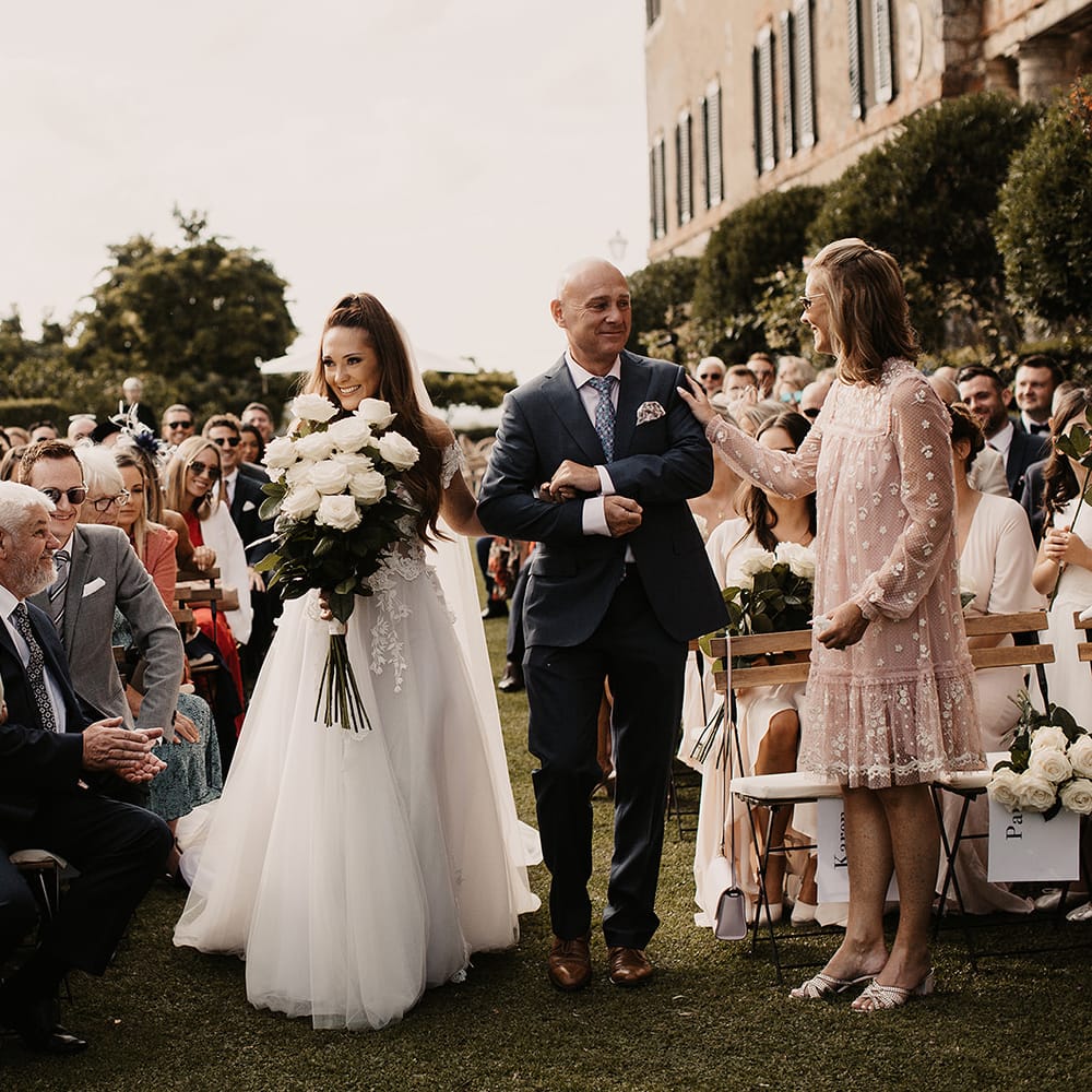 Bride in Galia Lahav dress with large white rose bouquet
