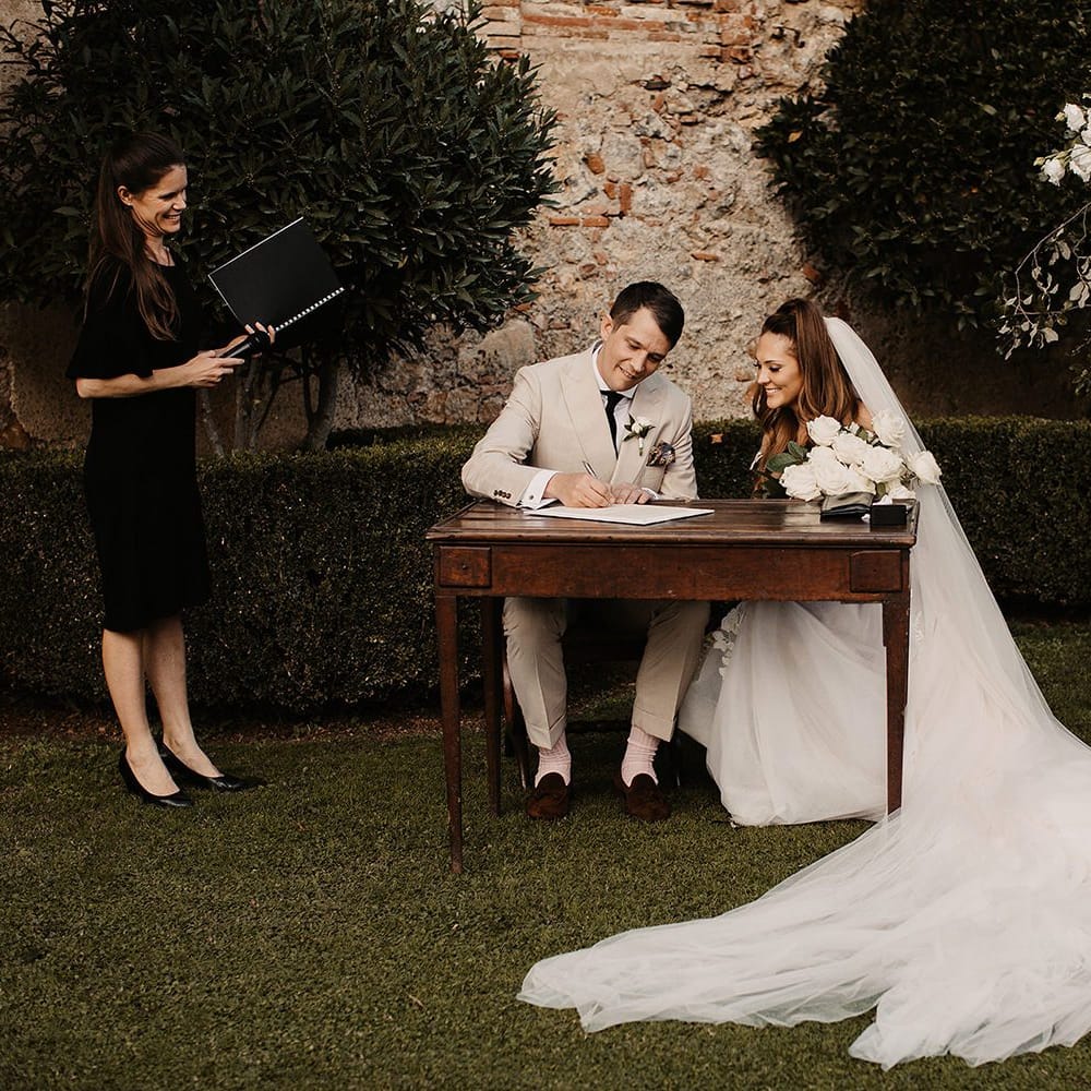 Bride and groom sign the wedding register