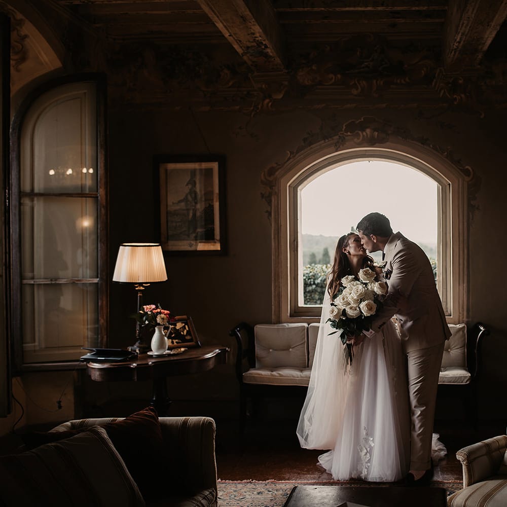 Bride and groom with large white rose bouquet