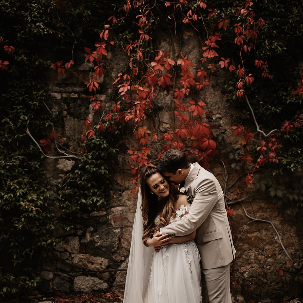 Bride in Galia Lahav wedding dress with groom in cream suit
