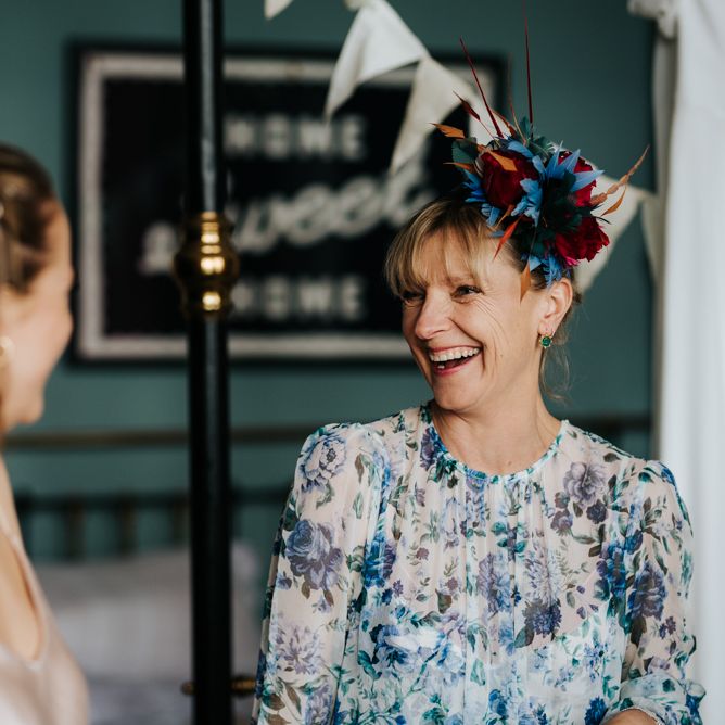 Bride's mother smiles at sister of the bride