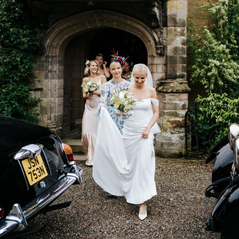 Bride in off the shoulder wedding dress going to the church