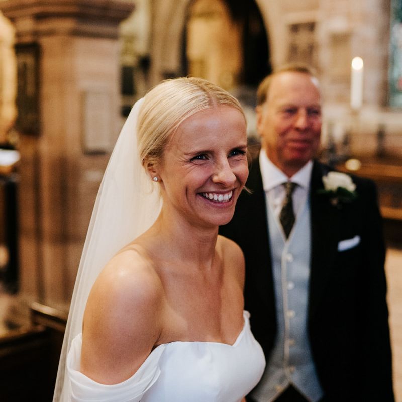 Bride smiles at someone off-camera