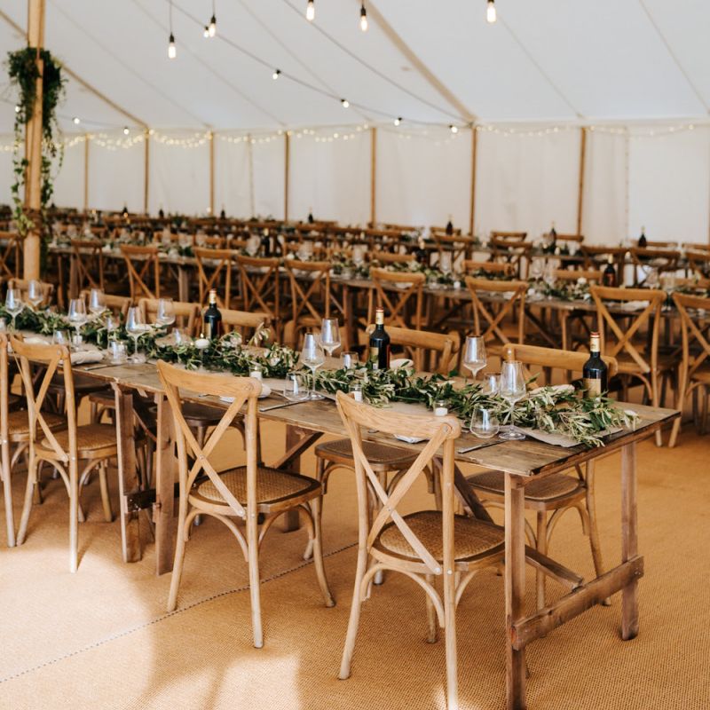 Hanging festoon light installation with foliage decor