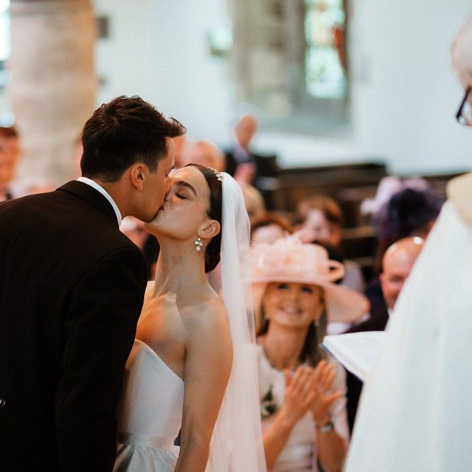 Bride and Groom Kiss During Ceremony