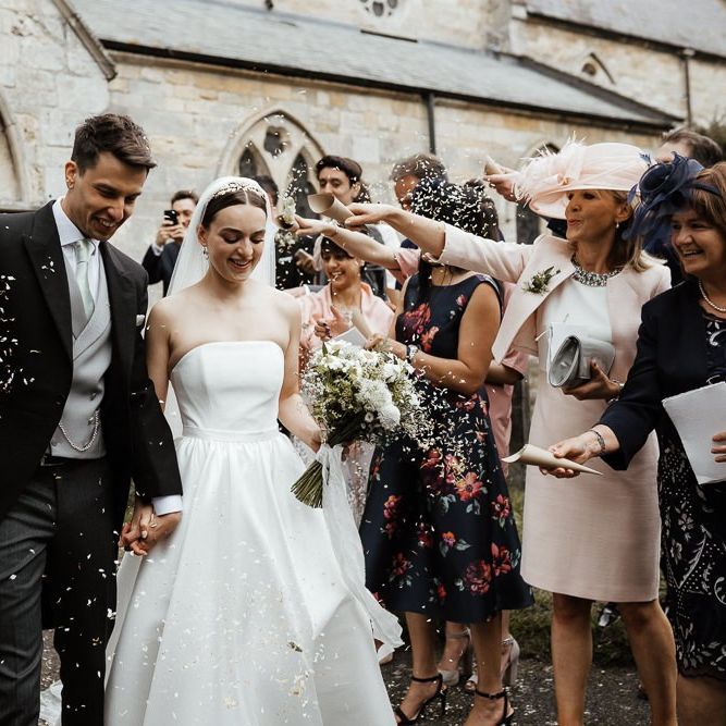 Confetti Exit For Bride In Strapless Wedding Dress And Groom  In Tail Suit