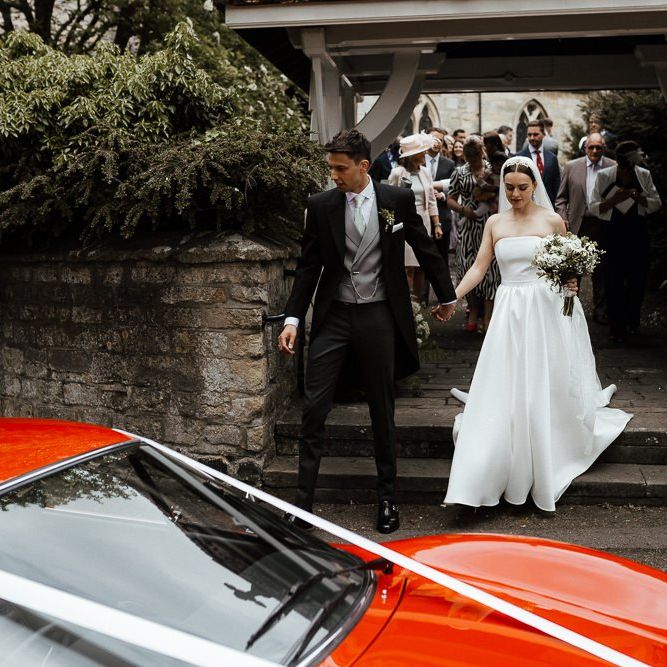 Bride and Groom Make Their Way To Wedding Transport