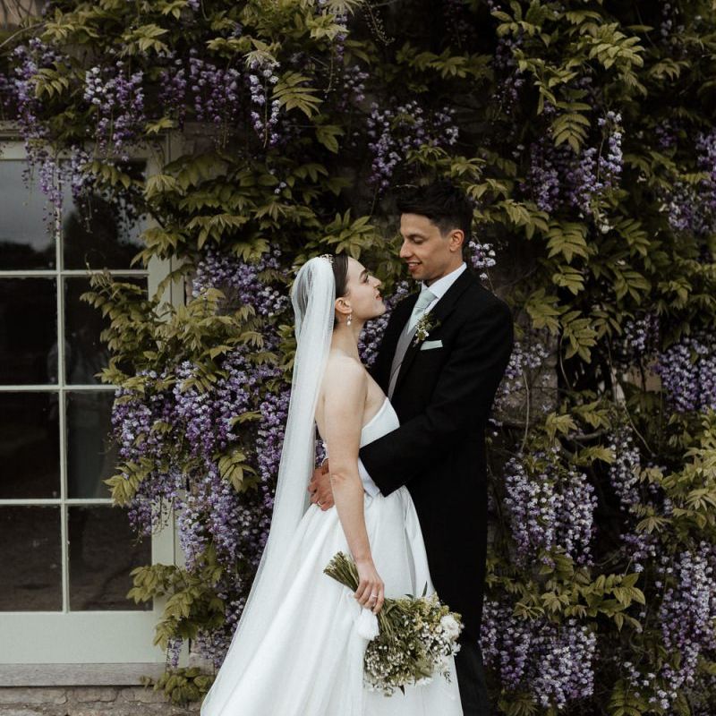 Bride In Strapless Wedding Dress With Bouquet And Veil