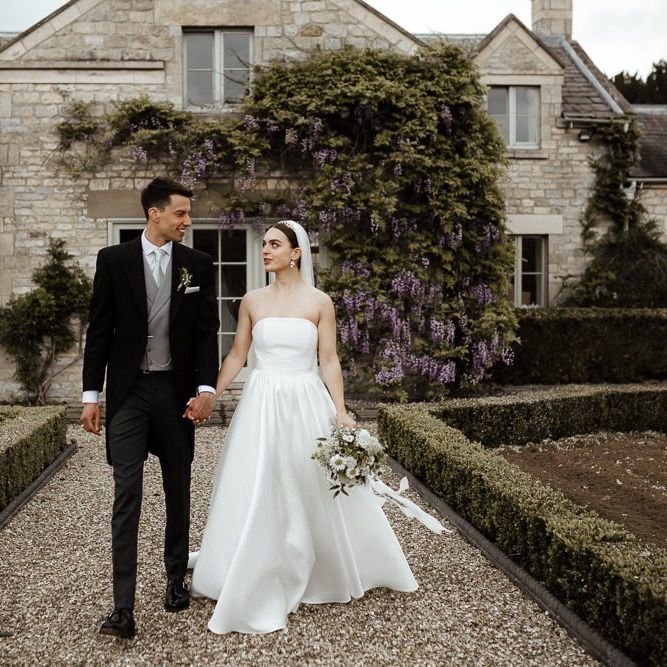 Bride In Strapless Wedding Dress With Bouquet And Veil