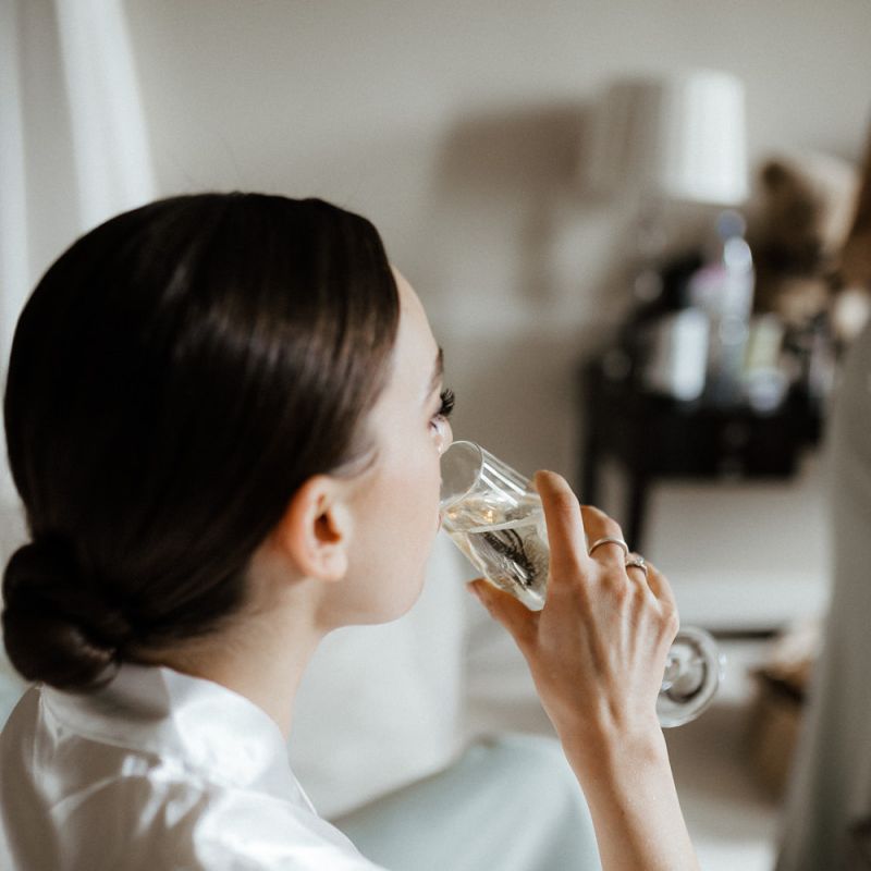 Bride Takes A Sip Of Champagne