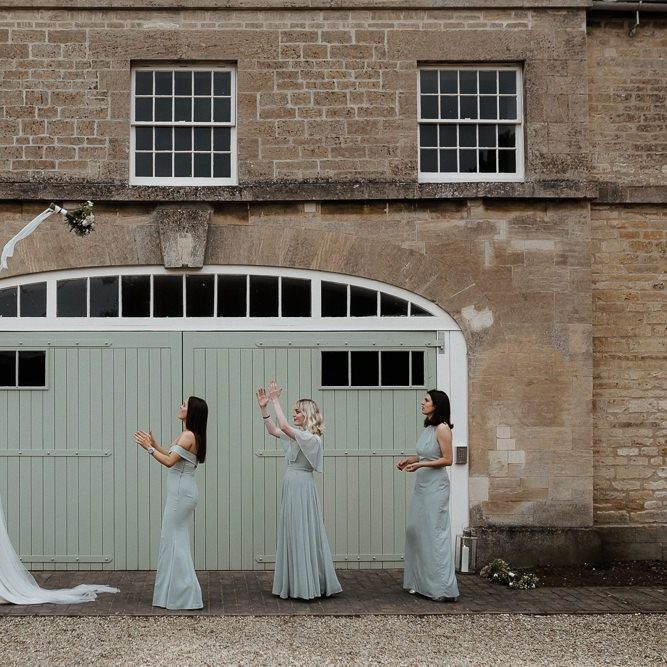 Bride In Strapless Wedding Dress Throws Bouquet To Bridesmaids
